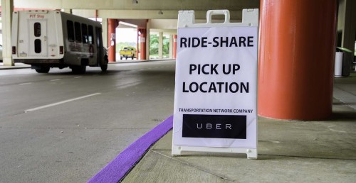 Temporary sign at PIT Airport marks where Uber pick-ups are allowed.