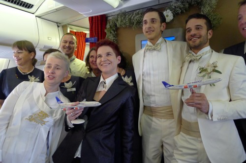 SAS same-sex, in-flight wedding couples received models of their wedding airplane
