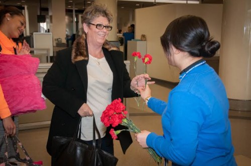 Philadelphia International Airport team members hand out red carnations for Valentine's Day 2015