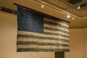 Flag of military uniforms on display at San Antonio Int’l Airport